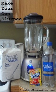 a blender sitting on top of a kitchen counter next to bottles of water and other items