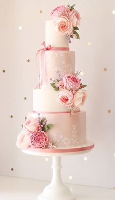 a three tiered wedding cake with pink flowers on top