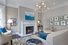 a living room filled with furniture and a fire place in the middle of a room