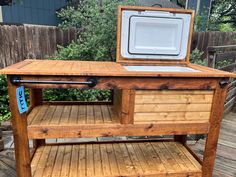 an old wooden table with a cooler on top