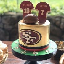 a cake with two football jerseys on top of it and some pastries in the background