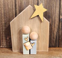 two wooden figurines with a star above them