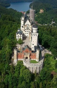 an aerial view of a castle surrounded by trees