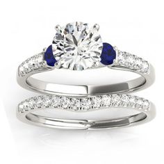 a diamond and blue sapphire engagement ring set with matching wedding bands on the band, in 18k white gold