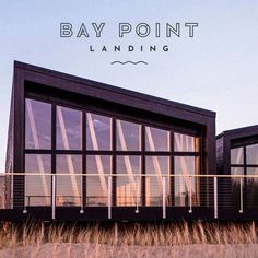 an advertisement for bay point landing with the sun setting in the background and tall grass