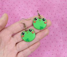 Hi CutiePie,  We're funny frogs earrings. We're earrings created from polymer clay without using any molds and completely handmade. We can be a funny gift for people of all ages. We'll always cheers You up and will bring a smile on your face.Our dimensions are:Length 0.8" ( or 2 cm. )Width 1" ( or 2.5 cm. )❀We come in a pretty box but please note in the event that several items are purchased all of us will ship in one box.❀ Because we're made by hand, we may differ slightly than shown on the pic Handmade Polymer Clay Fun Jewelry, Playful Green Polymer Clay Jewelry, Cute Handmade Green Jewelry, Quirky Handmade Resin Jewelry, Cute Green Hand Painted Jewelry, Fun Polymer Clay Nickel-free Jewelry, Handmade Playful Green Earrings, Playful Handmade Green Earrings, Fun Nickel-free Polymer Clay Jewelry