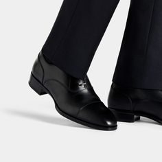 A classic pairing to formal suits, these timeless black Oxfords are crafted in Italy from supple Italian calf leather in a Blake stitch, and feature full leather lining and sole. Black Cap Toe Semi-formal Loafers, Fitted Black Leather Shoes For Semi-formal Occasions, Timeless Dress Shoes For Derby, Formal Goodyear Welted Plain Toe Oxfords, Classic Fitted Loafers With Brogue Detailing, Timeless Goodyear Welted Dress Shoes For Office, Classic Wingtip Loafers, Timeless Fitted Goodyear Welted Oxfords, Timeless Semi-formal Oxfords With Leather Sole