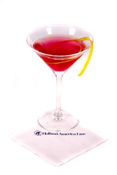 a red drink in a martini glass with a lemon slice on the rim