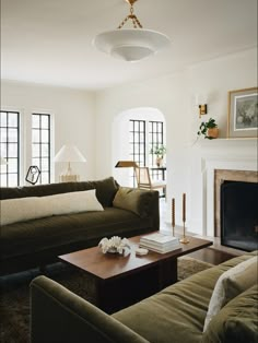 a living room filled with furniture and a fire place