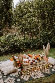 an outdoor picnic is set up in the grass with food and decorations on it, along with a sign that says merry christmas