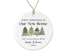 a christmas ornament with trees and the words, first christmas in our new home