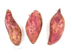 three different types of sweet potatoes on a white background, one is red and the other has yellow speckles