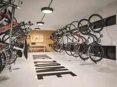 there are many bikes that are on the wall in this bike racked room,