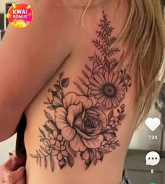 a woman's back with flowers and leaves on it