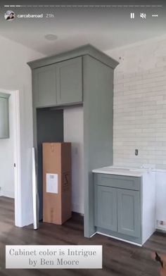 an empty room with cabinets and boxes on the floor