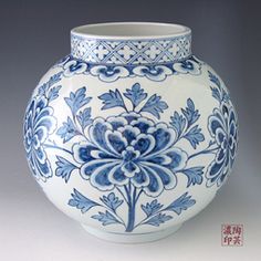 a blue and white vase sitting on top of a table