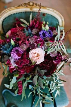 a bouquet of flowers sitting on top of a green chair