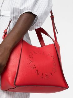 In a bold, notice-me shade of bright red, this Stella Logo crossbody tote bag is an escapist, timeless design. Consciously crafted from Alter Mat, a smooth and butter-soft vegan alternative to leather, the tote has two top handles along with a crossbody strap for adaptable wearing. Perforated Stella McCartney logo on front Grained Eco Alter Mat vegan alternative to animal leather Contrast single stitching Two top handles Adjustable crossbody strap Stainless steel and recycled brass hardware Deta Stella Logo, Stella Mccartney Logo, Vegan Alternatives, Crossbody Tote Bag, Crossbody Tote, Bright Red, Stella Mccartney, Sale Items, Timeless Design