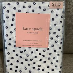 the packaging for kate spade new york's standard pillowcase is shown in black and white flowers