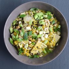 a white bowl filled with food on top of a table