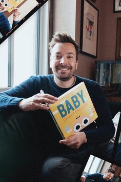 a man sitting on a couch holding a baby book