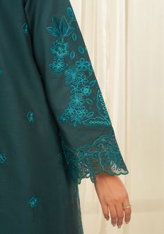 Brand: ZarqashProduct Code: ZQT 0011 DINACollection: Zarqash Tresor Unstitched Luxury Lawn CollectionFabric: Lawn DESCRIPTION “Dina ” embodies timeless elegance with its elaborate floral pattern in deep azure blue, enriched by cutwork detailing and vibrant thread work in jade and aqua green. The painstakingly embroidered border exudes opulence, elevating the ensemble to regal heights. The sumptuously printed silk dupatta adds a playful charm, infusing the look with dynamic energy. This meticulously crafted masterpiece captivates with its harmonious blend of sophistication and vivacity, enticing the beholder with its intricate beauty and luxurious allure. In “DINA,” every stitch tells a story of refined artistry and enchanting grace, making it a true symbol of sartorial excellence. DESIGN D Embroidered Trousers, Embroidered Sleeves, 3d Crystal, Pakistani Dress, Cotton Trousers, Pakistani Dress Design, Silk Dupatta, Slate Gray, Extra Fabric