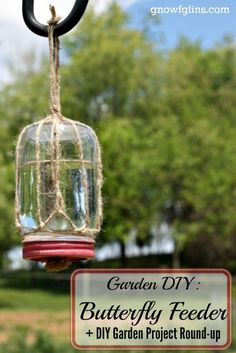 the garden diy butterfly feeder is hanging from a rope with text overlay that reads garden diy butterfly feeder + diy garden project round - up