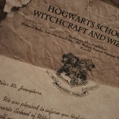 the hogwart's school certificate is on top of a piece of parchment paper