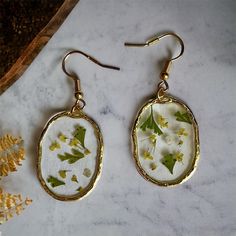 "These are one of a kind handmade earrings, made with real dried and pressed flowers.  I am inspired by nature and especially the Cottage Core style. I hope you enjoy! Material: The earring hooks  are made of nickel-free & lead-free metal alloy, durable, comfortable to wear and not easy fade. **In order to preserve your item, please do not add perfumes, or lotions to jewelry as it could tarnish. Remove jewelry before swimming or showering.** Please keep in mind these are handmade items so colors, slight differences and or \"defects\" may be present. I aim for all my creations to be beautiful and of good quality so if you have any questions, concerns or issues please do not hesitate to reach out to me and I would be more than happy to help. Thank you for stopping by!" Botanical Pressed Flower Earrings For Gift, Botanical Pressed Flowers Earrings As A Gift, Botanical Style Pressed Flowers Earrings For Gift, Nature-inspired Dangle Earrings With Pressed Flowers, Nature-inspired Green Earrings With Pressed Flowers, Nature-inspired Flower Earrings For Birth Flower Gift, Nature-inspired Flower Earrings With Birth Flower For Gift, Nature-inspired Dangle Flower Earrings, Handmade Nature-inspired Flower Earrings