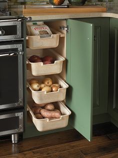 a kitchen with an oven, stove and food storage containers on the bottom shelf in front of it