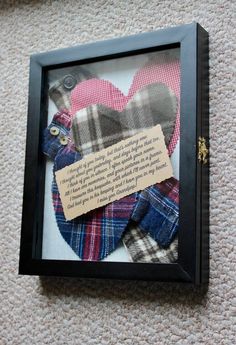 a framed piece of fabric with a note pinned to it that says, i love you