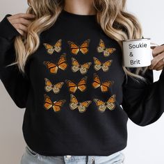 Looking for the perfect sweatshirt to show your love of butterflies or to gift a someone special in your life? Look no further! Our Monarch Butterfly sweatshirt features minimalist style and a soft and comfy feel. Whether it is for a birthday, Christmas, or just because, she will love this gift! SIZING *This is a true-to-size unisex sized sweatshirt.  *Classic Fit *Please read the sizing guide carefully to ensure correct sizing. *Measuring a favorite sweatshirt will help in finding the correct s Affordable Butterfly Print Crew Neck Top, Butterfly Sweat Shirt, Butterfly Nike Sweatshirt, Women Cottagecore, Butterfly Sweatshirt, Sweatshirt For Women, Fall Shirt, Cute Spring, Branded Sweatshirts