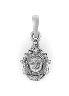 a silver pendant with a face on it