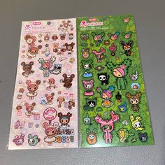 two sheets of stickers with different animals and other things on them, one is green and the other is pink