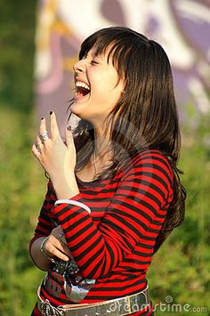 a young woman singing into a microphone