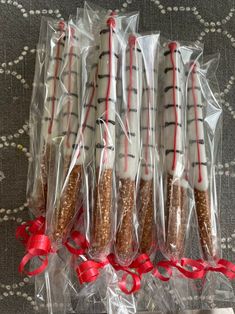 five wrapped cookies in plastic bags with red ribbon