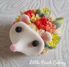 a close up of a cake shaped like a horse's head with flowers on it