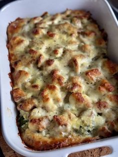 a casserole dish with meat and cheese in it sitting on a table top