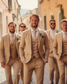 a group of men in tan suits standing next to each other