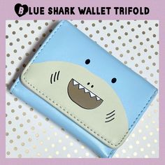 a blue wallet with a cartoon shark on it's face and the words blue shark wallet