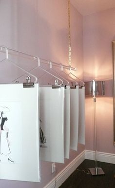 a bathroom with pink walls and an art work hanging on the wall next to it