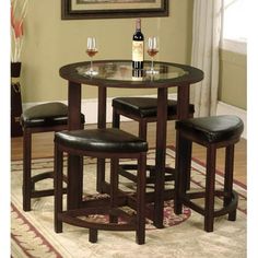 a dining room table with four stools in it