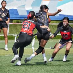 the girls are playing soccer on the field