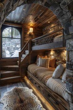 a bedroom with bunk beds in it and a stone staircase leading up to the second floor