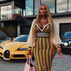 a woman in a yellow and black dress is standing next to two cars with her handbag