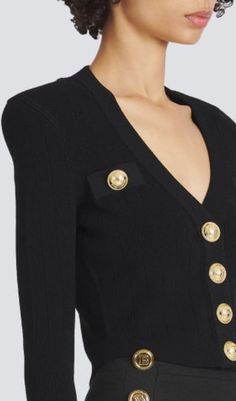 Elevate your wardrobe with this BLACK V-NECK METAL BUTTON CROPPED KNIT CARDIGAN, crafted from exquisite knit fabric for a sophisticated and stylish look. This versatile and timeless piece features a sleek V-neck, metal buttons, and a flattering cropped silhouette. A truly luxurious addition to any wardrobe. Gentle Dry Clean OnlyColour may vary due to lighting on images. The product images (without model) are closest to the true colour of the product.Item runs true to size chart and is cut to sui Luxury Fitted V-neck Cardigan, Chic V-neck Cardigan For Formal Occasions, Designer V-neck Cardigan With Button Closure, Luxury Black Sweater With Button Closure, Elegant Knit V-neck Outerwear, Fitted V-neck Sweater For Formal Occasions, Elegant Long Sleeve Sweater With Buttons, Formal Fitted V-neck Sweater, Elegant Black Fine Knit Cardigan