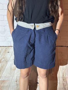 Step into retro glamour with these eye-catching vintage 1990s navy shorts!  The tailored fit and low-rise design give them a cool look, while the 1990s style brings back nostalgic vibes. Pair them with a tucked-in top or crop for a truly standout look. **Size Women's 26" Waist   **Measurements   - Waist: 26 inches   - Hips: 36 inches   - Rise: 11 inches   - Inseam: 3 inches   - Length (waist to hem): 14 inches   **Condition Excellent vintage condition with minimal signs of wear. **Features     - 1990s Style, 90s Glam, Nostalgic Vibes, Retro Glamour, 1990s Fashion, Cooler Look, Navy Shorts, Vintage Shorts, Fold Over