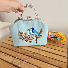 Hello! Welcome to my store! Wish you have a satisfactory purchase! If you need to think of a beautiful, meaningful and impressive gift for your lover, mother or friends, this will be the perfect choice for you! Your search ends with this stunning mint green bird embroidered bag! This handcrafted embroidered shoulder bag makes a lovely gift for Mother's Day or any special occasion. Since its strap is removable, you can use it as an evening bag, make-up bag or handbag. One bag, two styles! Bird Embroidered Bag will be a privileged piece for you and your loved ones.    Crafted from light blue and mint green stain-resistant linen fabric, this top-handle shoulder bag exudes elegance and sophistication. Each bag is meticulously embroidered by master craftsmen using ribbon embroidery and rococo e Spring Gift Bag With Detachable Handle, Spring Gift Bags With Detachable Handle, Summer Gift Bag With Detachable Handle, Blue Mobile Phone Evening Bag, Blue Embroidered Bag For Daily Use, Light Blue Pouch Bag As Gift, Light Blue Pouch Bag For Gift, Blue Top Handle Shoulder Bag For Spring, Rectangular Blue Embroidered Shoulder Bag