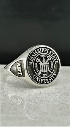 "Made to order - 925 sterling silver signet ring engraved with your college logo, your family crest or any other image that you request. No extra cost for side engravings. ✔Ring Details Metal: 925 Sterling SILVER Face Sizes (diameter): Small (10 mm), Medium (13 mm), Large (16 mm), X Large (19mm) After placing your order please send us a HIGH QUALITY digital image you would like me to use. Even if I have already been in contact with you PLEASE attach in the \"notes\" section your Size, Color and 1990 Class Ring, 1976 Class Ring, High School Rings, Class Rings College, University Rings, Class Rings High School, School Rings, College Class, Class Rings