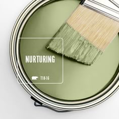 a green paint can with a brush in it and the words nurturing above it